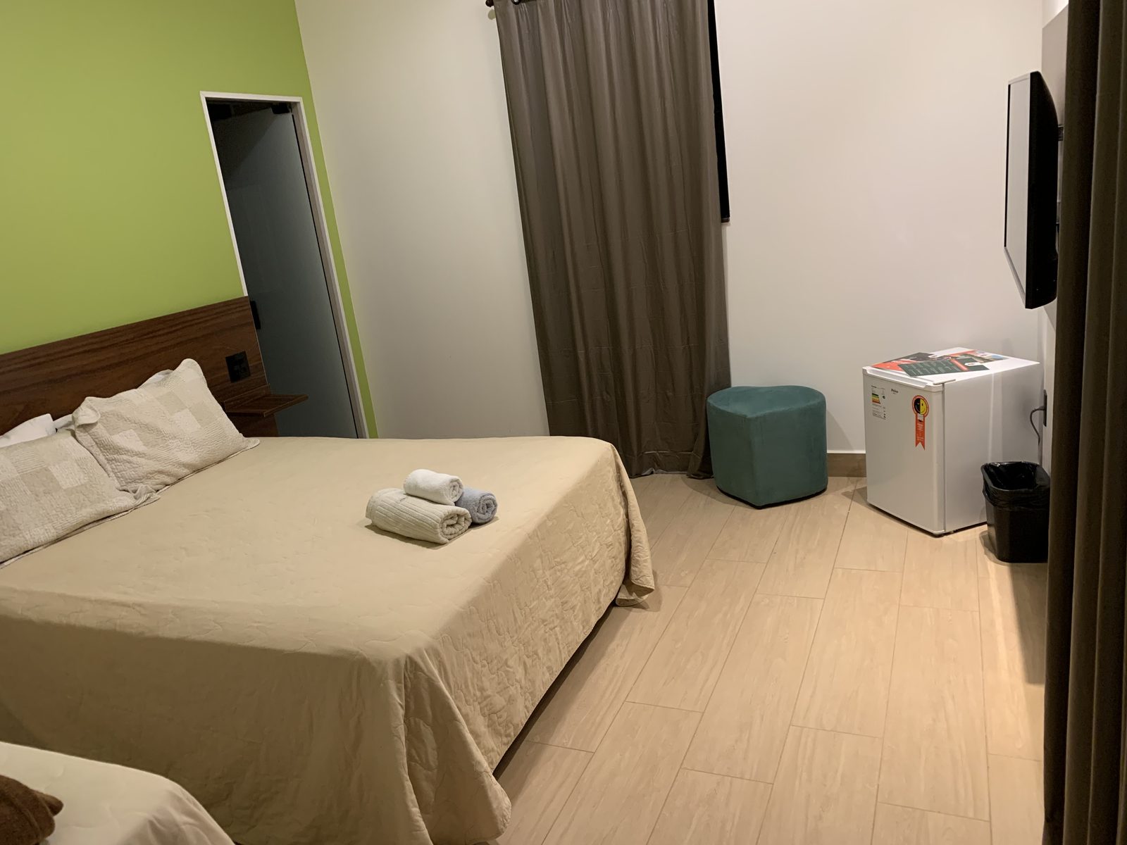 Apartamento Standard Triplo com cama de casal, parede verde, frigobar, TV e banheiro privativo no Hotel Holambra